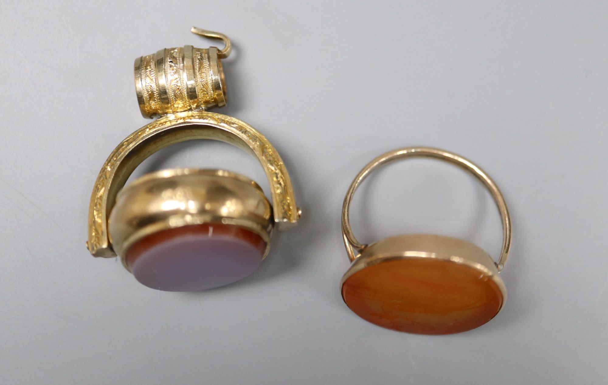 A Victorian 10ct and carnelian swivelling fob, 38mm and a similar yellow metal and carnelian ring